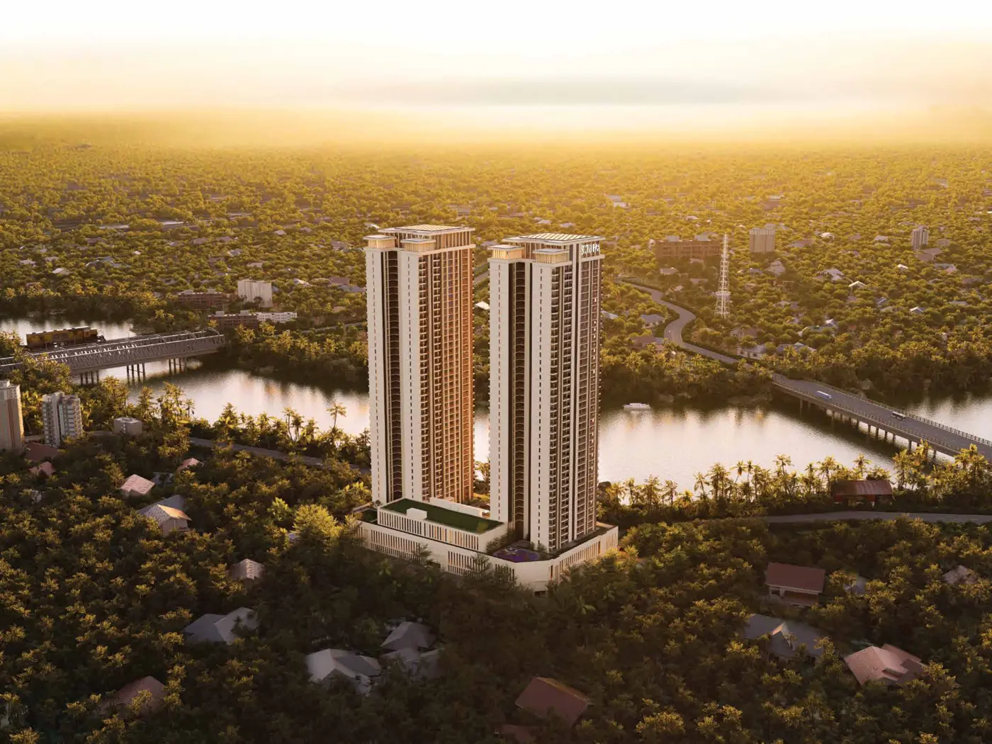Aerial golden-hour view of the twin towers beside the river