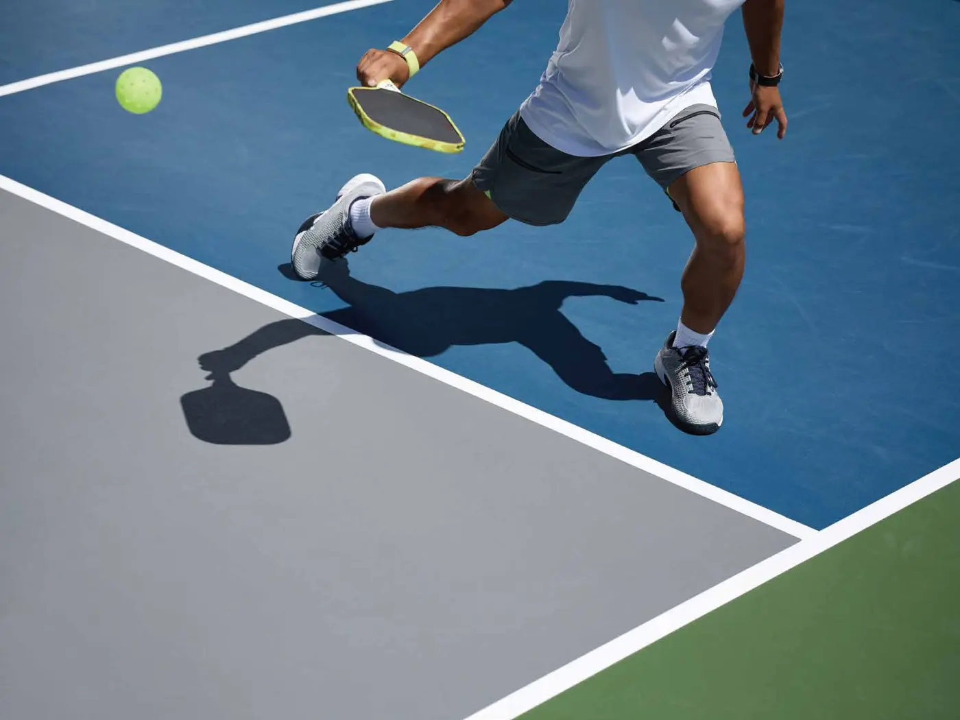 Resident playing pickleball on the court