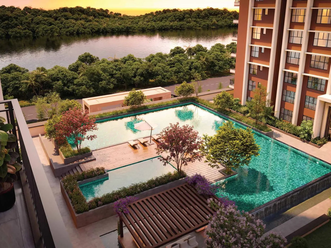Resort-style swimming pool overlooking the river at sunset